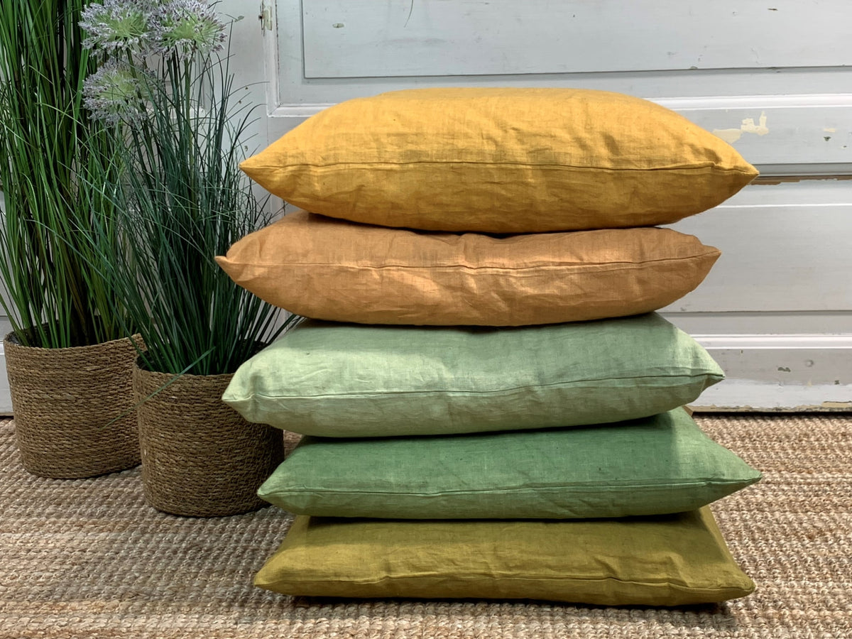 Linen pillows stacked and lying on top of each other