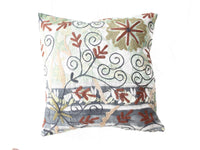Unique suzani pillowcase 50x50 cm with white base and vintage boho oriental floral and sling pattern in teal, rust, beige and black.